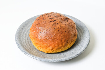 Close up view of choco bun on little grey or gray plate isolated on white background. clipping path, baked, brown.
