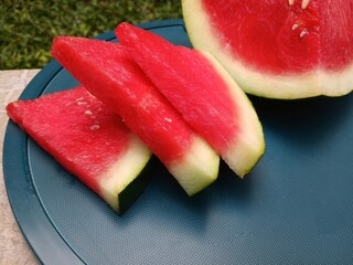 Fresh watermelon slices on a plastic tray ready to be enjoyed.