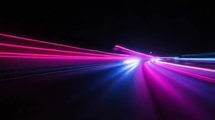 Streaks of blue and purple light blur across a dark road at night, creating an abstract sense of speed and motion - Powered by Adobe