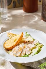 Caesar salad with chicken, bright morning lighting, overhead composition, crisp greens and artisanal croutons