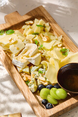 Cheese assortment platter, bright natural light, overhead composition, rustic artisan style