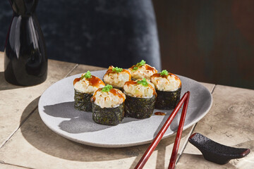 Scallop sushi roll with unagi sauce, bright lighting, elegant angled tabletop composition