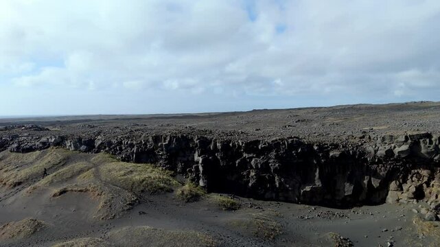 drone rotate around The Bridge between Continents footbridge spanning a rift between the Eurasian and North American tectonic plates in Iceland