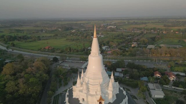Beautiful White And Gold Pagoda In Rural Central Thailand Asia Drone Pull Back Pan 4K 60FPS