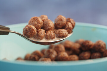 Pouring cereal into milk for a delicious breakfast meal