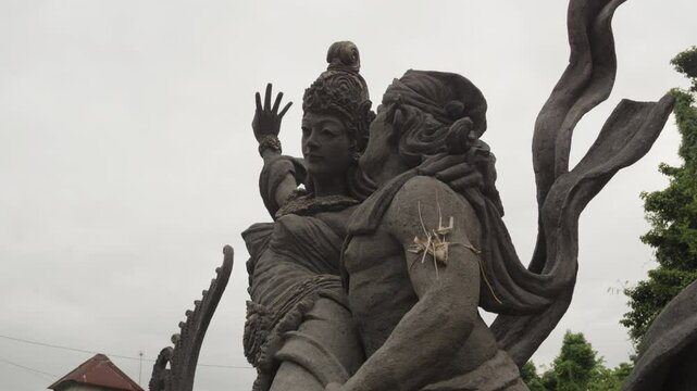 Stone sculpture in Ubud, Bali, depicts a Balinese Hindu couple, Indonesia.