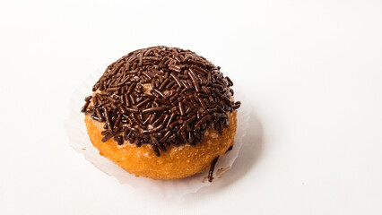 Delicious fried doughnut or donut topped with chocolate sprinkles isolated on white background.