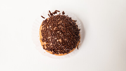 Delicious fried doughnut or donut topped with chocolate sprinkles isolated on white background.