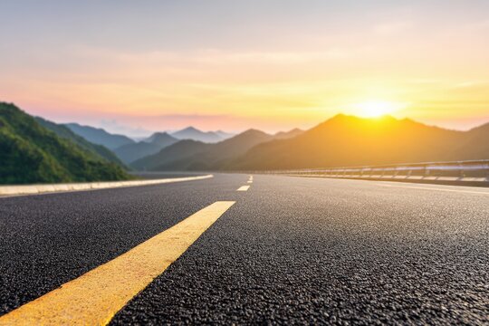 Empty asphalt road leading through a beautiful mountain landscape at sunset, perfect for design mockup or text advertisement