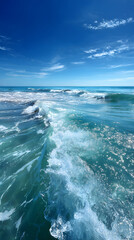 Infinite Turquoise: Capturing the Mesmerizing Dance of Ocean Waves Under Azure Skies with Shimmering Sunlit Crests
