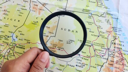 View of Sudan, on a geographic map of Africa, seen using a magnifying glass