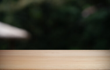 Empty wood table top and blur of restaurant background selective focus product display