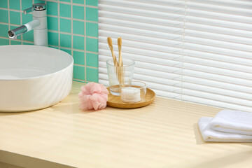 Contemporary bathroom counter with mint mosaic tiles, soap tray, and fluffy sponge. Ample blank...