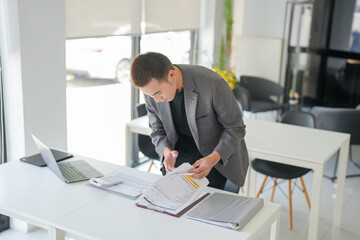 Young business man busy working at office. businessman doing financial paperwork business management concept.