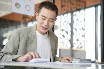 Confident asian business man Auditor or internal revenue service staff checking annual financial...