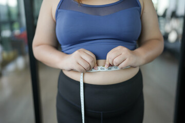 Obese Woman with fat belly in dieting concept. Overweight woman touching his fat belly and want to...