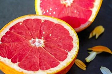 A juicy macro close-up of a halved red grapefruit showing its texture.