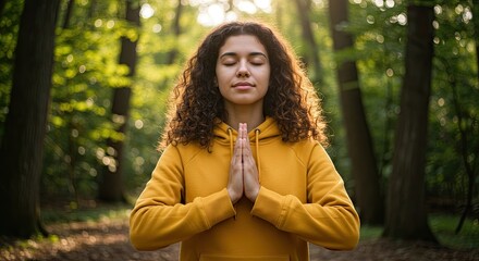 Woman meditating in forest