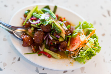 Spicy Chinese sausage salad. Yam Kun Chiang with cucumber and vegetables, Thai food combination Chinese Food fusion, sweet sausage style, decorative carved cucumber ,chili and spring onion