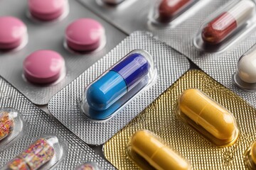 A close-up of various pills and capsules in their packaging, showcasing the diversity and variety of medical tablets and capsules on display, high-resolution photography, stock photo, professional 