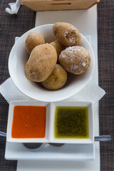 Portion of canarian potatoes (papas arrugadas) with red and green mojo sauce. Typical dish of the Canary Islands