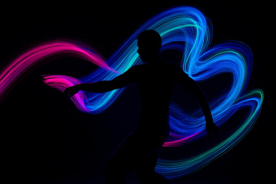 AI generated abstract image of a dancing human silhouette surrounded by glowing neon light trails in pink blue green and cyan representing motion rhythm emotion and futuristic expression