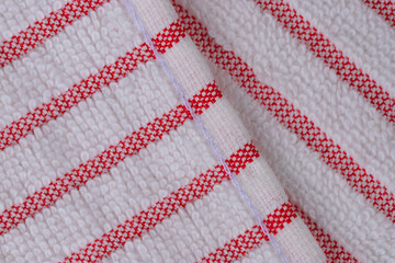 multi-colored striped terry towels for the kitchen with a loop for hanging on a hook, isolated