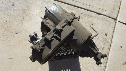 Dirty Greasy Transfer Case from a 1980s 4x4 SUV Sits on a Driveway 