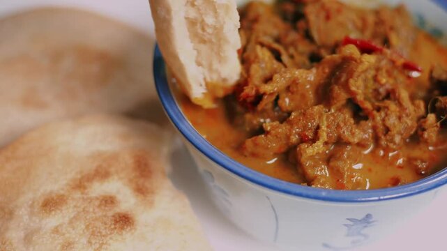 Beef curry served with homemade sourdough pita breads on table. Healthy, diet eating food. Low calories bread