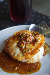 Pontianak Egg Rice, West Kalimantan, Indonesia, captured on July 4, 2025. Rice dish with fried egg, soy-based sauce, and crispy shallots for a simple yet bold flavor.