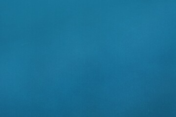 Abstract flat design is showing uniform teal-blue background with subtle texture filling full frame