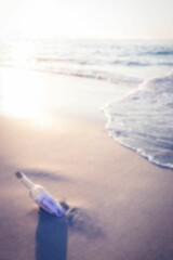 Message in a bottle at sunny sea shore