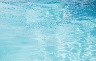 Flat design water surface is shimmering under bright sunlight with subtle ripples and reflections