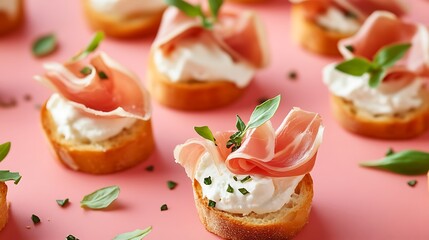 Prosciutto appetizer bites with creamy cheese and fresh basil on a vibrant pink surface, perfect for parties and culinary creations.