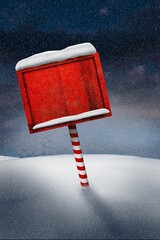 Red wooden signboard candy-striped pole are standing amid falling snow on snowdrifts under dark sky