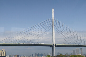 Fototapeta premium Osaka, Japan – April 15, 2024: Tempozan Bridge is a cable-stayed bridge spanning the mouth of the Ajigawa River. The view is from inside a gondola of the Tempozan Giant Ferris Wheel.