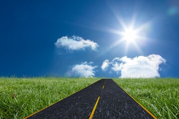 Flat design illustrating straight asphalt road with yellow lines crossing meadow under sunny sky