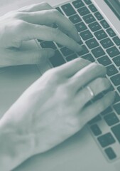Cropped image of person using laptop