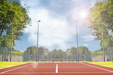 Composite image of tennis field on a sunny day