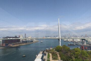 Osaka, Japan – April 15, 2024: Tempozan Bridge is a cable-stayed bridge spanning the mouth of the Ajigawa River. The view is from inside a gondola of the Tempozan Giant Ferris Wheel.