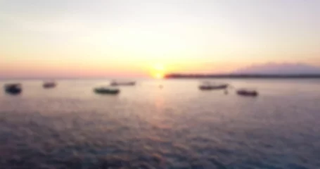 Gardinen Defocused image of boats moored on sea © vectorfusionart