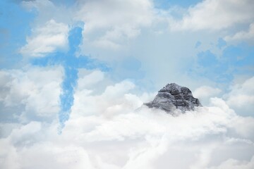 Solitary jagged mountain peak is rising through clouds in flat design, with cross-shaped mist