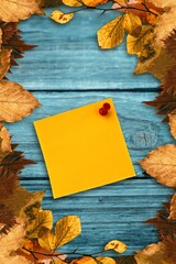 Autumn leaves with yellow note