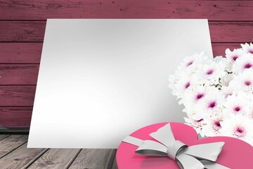 Box and flowers on wooden background