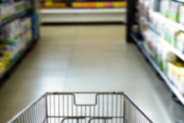 Shopping cart on aisle at supermarket