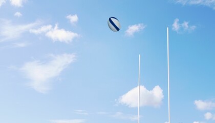 Rugby ball flying between posts