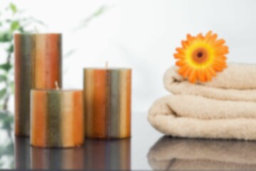 Candles with orange Gerbera daisy on towel