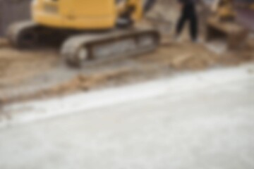 Bulldozer levelling mud at construction site