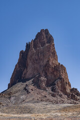 Fototapeta premium Agathlan / Agathla Peak is an eroded volcanic plug consisting of volcanic breccia / Intrusive breccia ( Ti ). south of Monument Valley, Arizona. U.S. Route 163 (U.S. Highway 163, US 163)