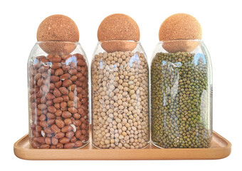 Three glass jars containing peanuts, soybeans, and mung beans with cork lid. Healthy products...